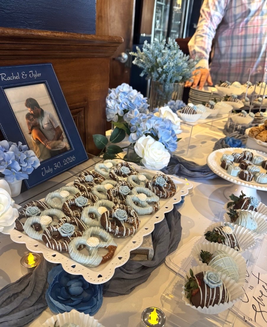 Custom dessert table with chocolate-dipped pretzels and strawberries