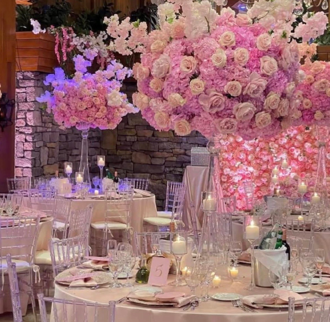 Lush pink and blush floral installation above an elegant tablescape
