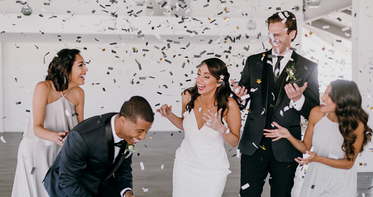 Wedding party celebrating with confetti